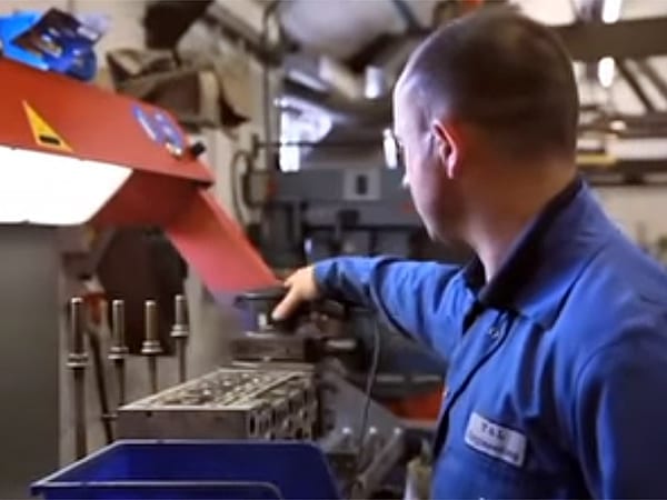 Man Cleaning Cylinder Head | T&L Engineering Bedford